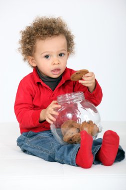 Portrait of infant eating cookies clipart