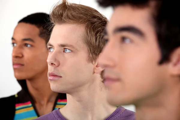 Three young men in profile — Stock Photo, Image