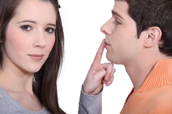 Girlfriend shushing boyfriend — Stock Photo, Image