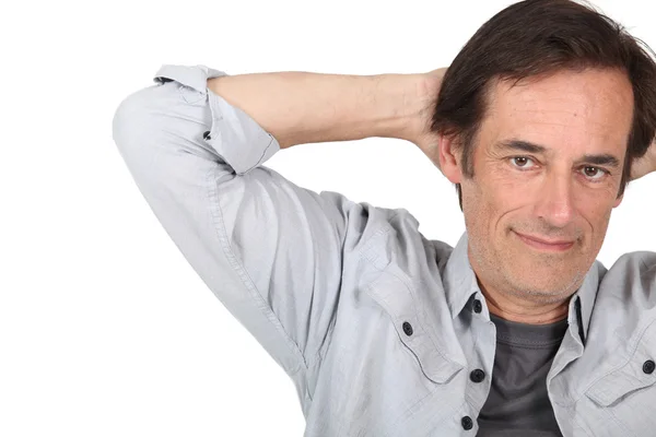 Man relaxing with arms behind head. — Stock Photo, Image