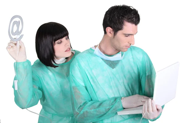 Surgeon and assistant saving laptop — Stock Photo, Image
