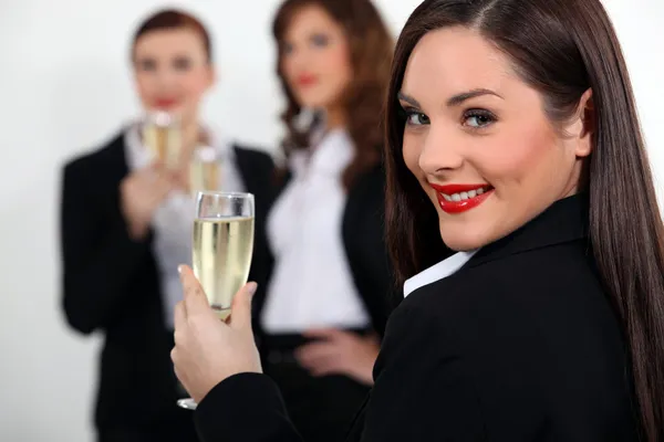 Three business women drinking sparkling wine Royalty Free Stock Images