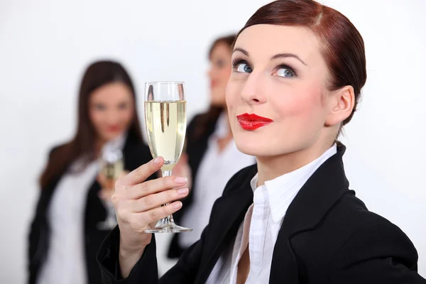 Females coworkers drinking champagne. Stock Picture