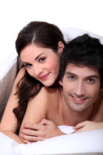 Couple laying in their bed Stock Photo
