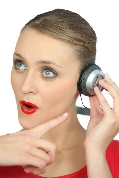 Surprised woman wearing headphones Royalty Free Stock Photos