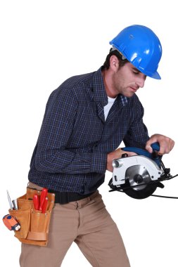 Tradesman using a circular saw clipart