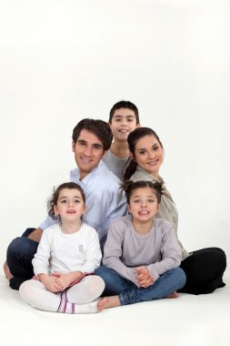 Parents with three children in studio clipart