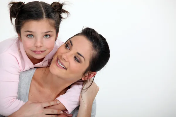 Young girl hugging her mother — Stock Photo, Image