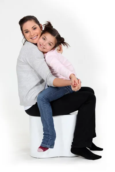 Little girl sat on mother — Stock Photo, Image