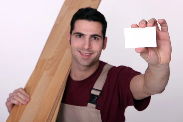 Floorer showing business card to camera — Stock Photo, Image
