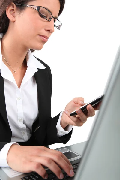 Businesswoman, with mobile telephone and laptop computer — Stock Photo, Image