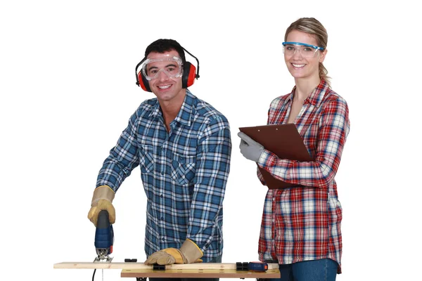 Couple using an electric jigsaw — Stock Photo, Image