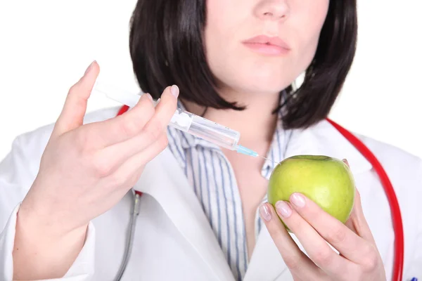 Doctor injecting hormone drugs into an apple — Stock Photo, Image