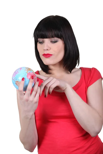 Brunette holding a miniature globe — Stock Photo, Image