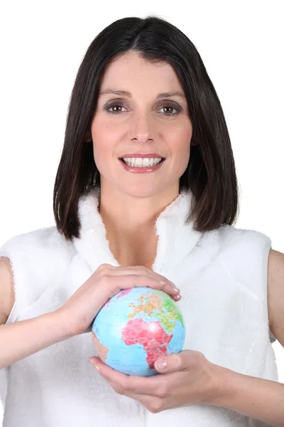 Woman holding a mini-globe — Stock Photo, Image