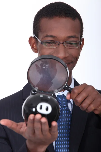 Black man with a magnifying glass — Stock Photo, Image