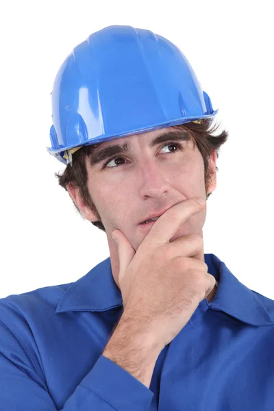 A pensive manual worker. Stock Photo