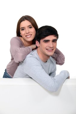 Young couple sitting on a couch clipart