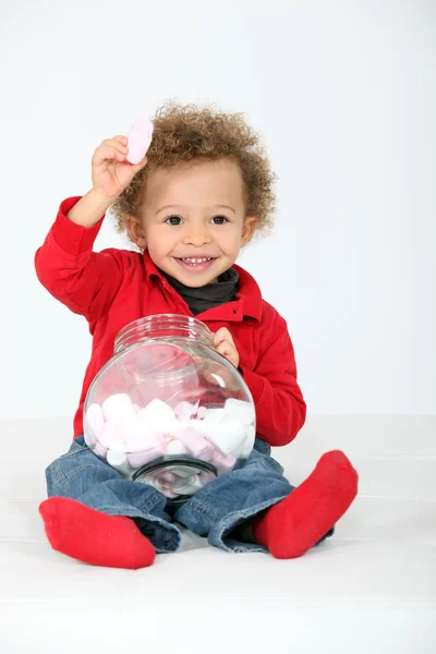 Little boy eating sweets — Stock Photo, Image