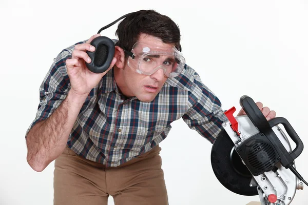 Carpenter lifting his earmuff to listen to you — Stock Photo, Image