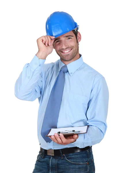 Friendly chap with a clipboard and helmet — Stock Photo, Image
