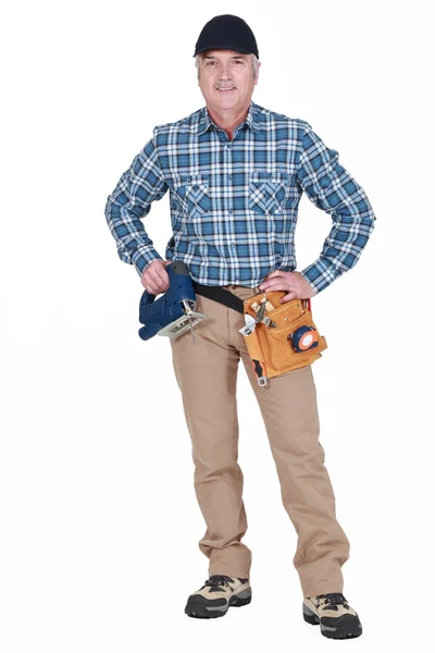 Middle-aged worker with band-saw Royalty Free Stock Images