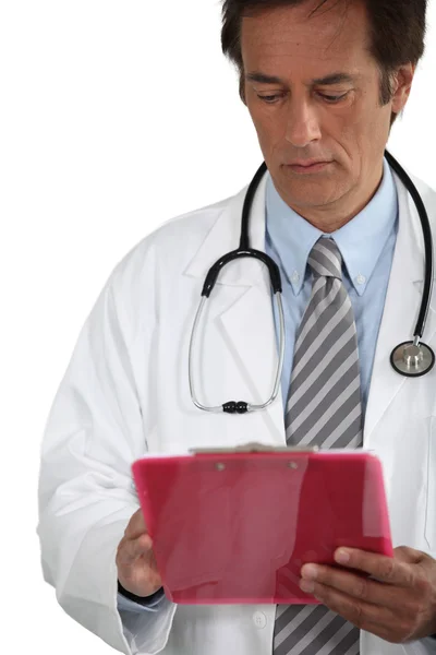 Doctor looking at clipboard — Stock Photo, Image