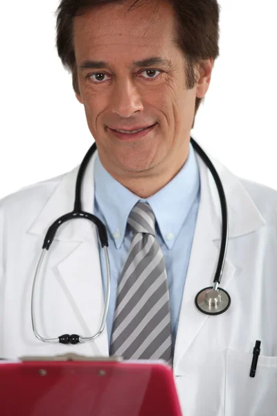 Doctor smiling with clipboard — Stock Photo, Image