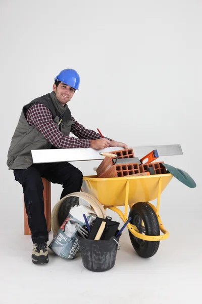 Mason surrounded by equipment — Stock Photo, Image