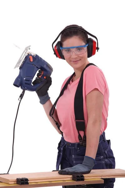 Woman using an electric saw — Stock Photo, Image