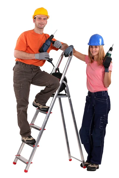 Tradesman posando com seu jovem aprendiz — Fotografia de Stock