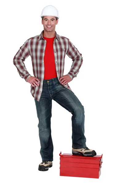 Male builder stood on toolbox — Stock Photo, Image