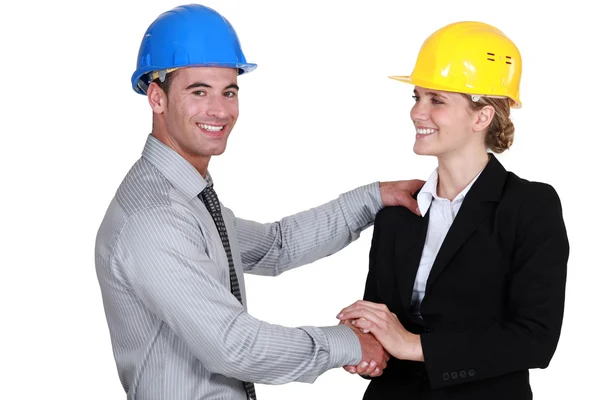 Male and female architects shaking-hands Royalty Free Stock Images