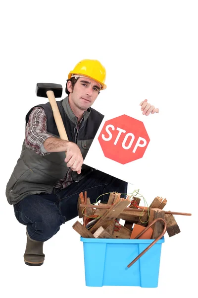 Builder kneeling by recycle box — Stock Photo, Image