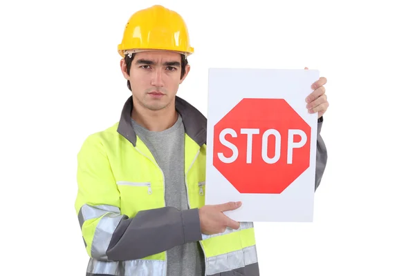 Worker holding stop sign — Stock Photo, Image