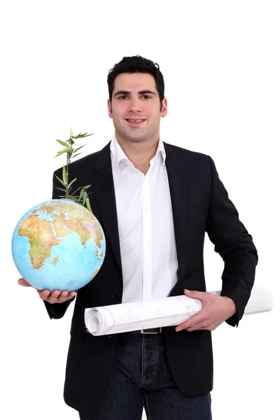 Man stond met globe en plant Stockafbeelding