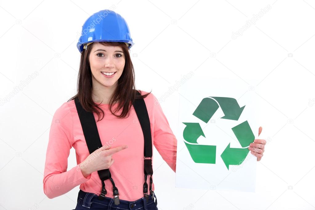 Young craftswoman showing recycling logo