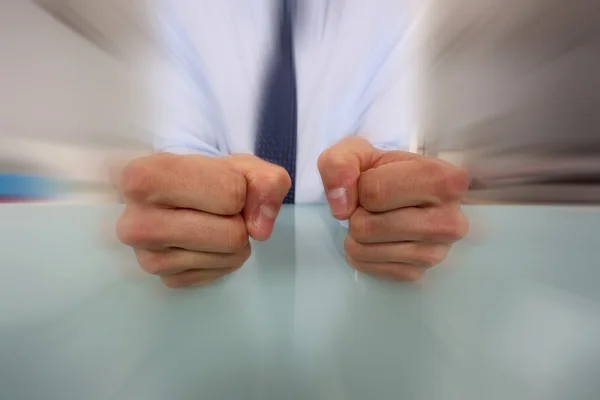 Empresário batendo seus punhos em sua mesa — Fotografia de Stock