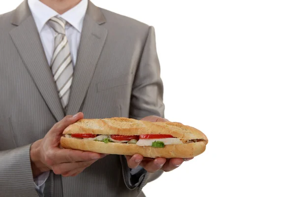 Homme d'affaires tenant un sandwich long — Photo