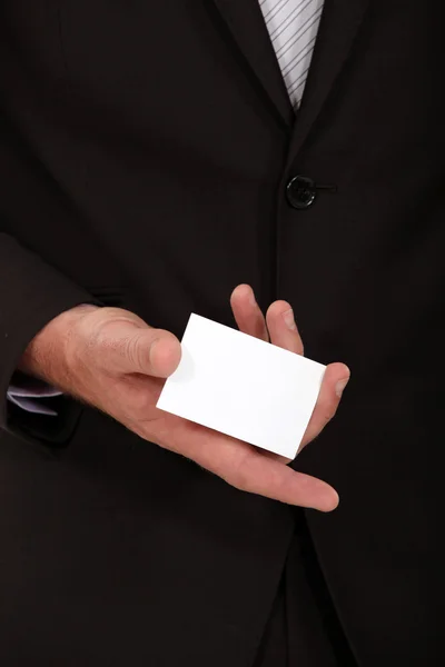 Businessman displaying card — Stock Photo, Image