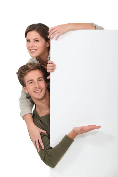 Couple stood by blank message board — Stock Photo, Image