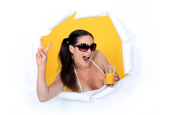 Woman coming out of hole with orange juice — Stock Photo, Image