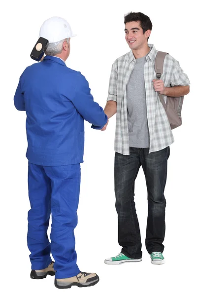A construction worker and his apprentice. — Stock Photo, Image