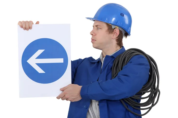 Electrician with a road sign — Stock Photo, Image