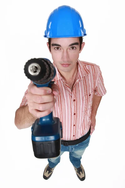 Tradesman segurando uma ferramenta elétrica — Fotografia de Stock