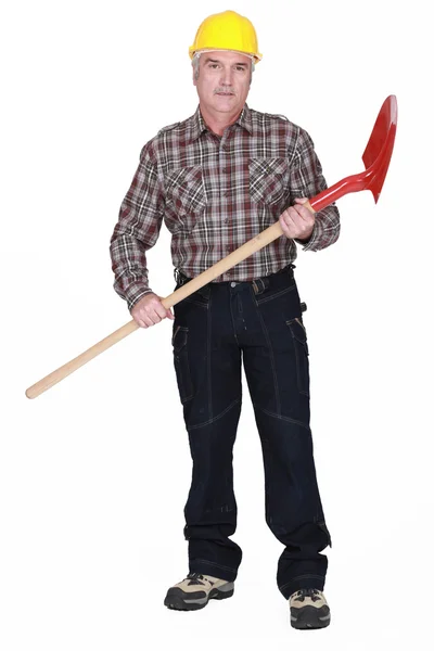 Grey-haired man with shovel — Stock Photo, Image