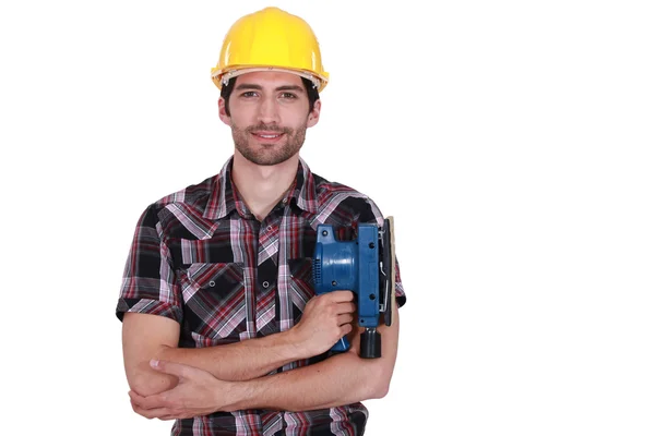 Carpintero posando con lijadora de potencia — Foto de Stock