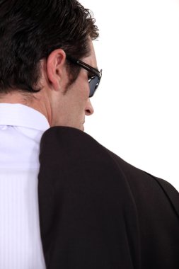 Mobster carrying his jacket over his shoulder clipart