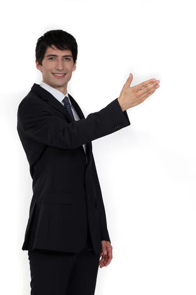 Businessman with arm stretched — Stock Photo, Image