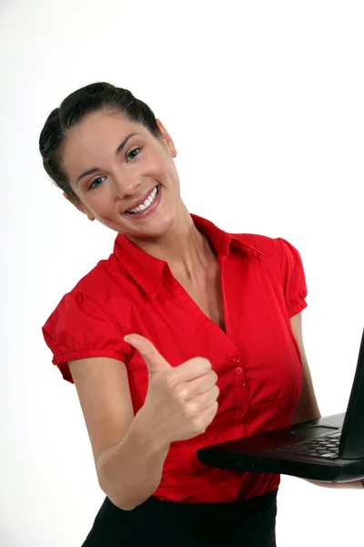 Brunette giving the thumbs-up to new laptop — Stock Photo, Image